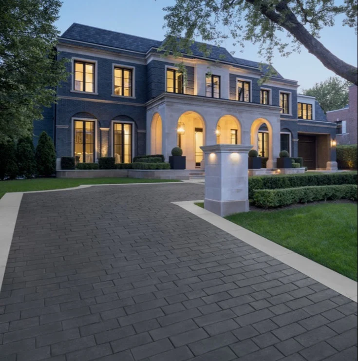 Luxury paver driveway at dusk on a residential property